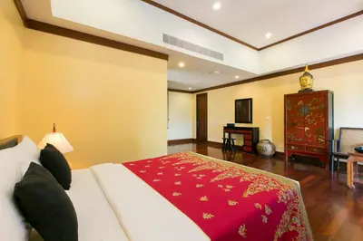 a bedroom with a bed with a red blanket on it at Katamanda villa Sooksan Near Kata Noi Beach in Kata Beach