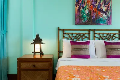 a bedroom with a bed and a table with a lamp at Katamanda villa Sooksan Near Kata Noi Beach in Kata Beach