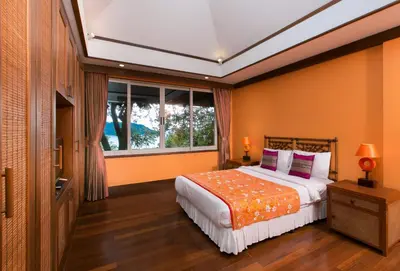 a bedroom with a bed and a window at Katamanda villa Sooksan Near Kata Noi Beach in Kata Beach