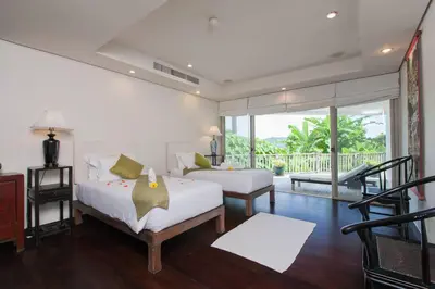 a bedroom with two beds and a balcony at Katamanda - Villa Katamalee Private Pool near Kata Noi Beach in Kata Beach