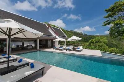 a swimming pool with chairs and umbrellas at Katamanda - Villa Katamalee Private Pool near Kata Noi Beach in Kata Beach