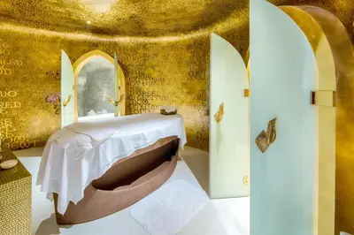 a room with a bed with a table and surfboards at Iniala Beach House in Natai Beach