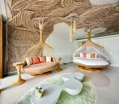 a living room with two chairs and a rug at Iniala Beach House in Natai Beach