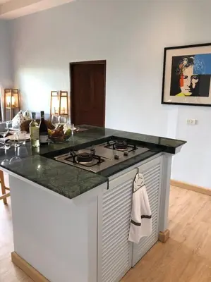 a kitchen with a stove and a counter top at 1 bedroom Villa on Ao Yon beach with sea views in Phuket Town