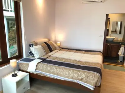 a bedroom with a large bed and a window at 1 bedroom Villa on Ao Yon beach with sea views in Phuket Town