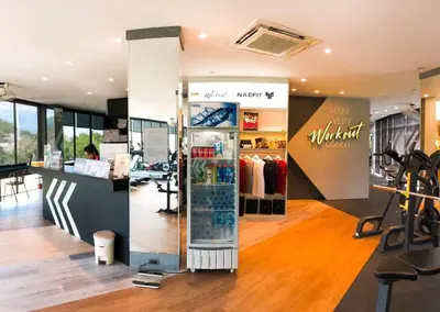 a clothing store with a woman sitting at a counter at Kamala Beach D49 Exclusive Junior Suite in Kamala Beach