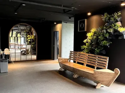 a wooden bench sitting in a room with plants at Kamala Beach D49 Exclusive Junior Suite in Kamala Beach
