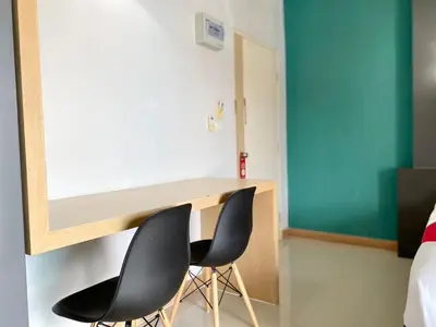a room with two chairs and a desk at Chalong - Studio Service Apartment - Phoomjai in Ban Klang