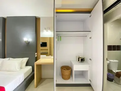 a small room with a bed and a bathroom at Chalong - Studio Service Apartment - Phoomjai in Ban Klang