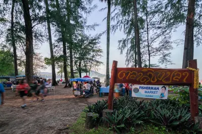 a sign in a park with people running around at SD Residence I Naiyang Beach I HKT Airport in Nai Yang Beach