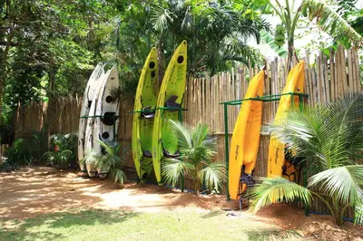 a bunch of surfboards leaned up against a fence at Baan Panwa Resort in Panwa Beach