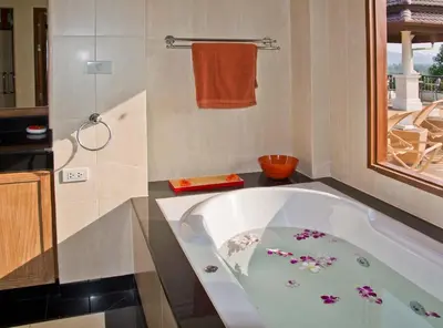 a bathroom with a bath tub with flowers on it at Villa Oriole in Layan Beach