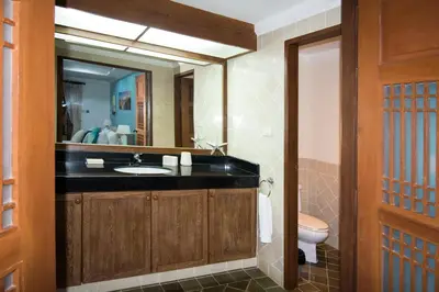 a bathroom with a sink and a mirror at Villa Oriole in Layan Beach