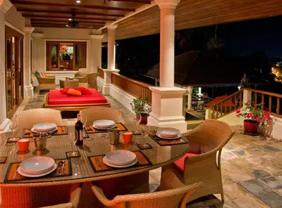 a dining table and chairs on a porch with a table and chairs at Villa Oriole in Layan Beach