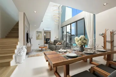 a living room with a table and a couch at Zenithy Pool Villas by Capitalpro ZEN-9 in Phuket Town