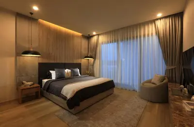 a bedroom with a bed and a couch and a chair at Zenithy Pool Villas by Capitalpro ZEN-9 in Phuket Town