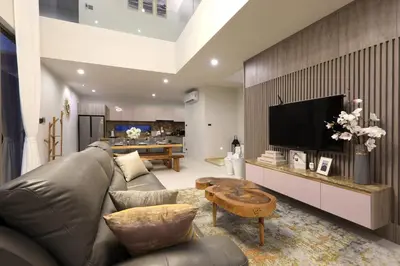 a living room with a leather couch and a television at Zenithy Pool Villas by Capitalpro ZEN-9 in Phuket Town