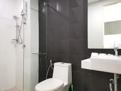 a bathroom with a white toilet and a sink at 7 Floor - Ozone Condotel near Kata beach by 15 minutes walking in Kata Beach