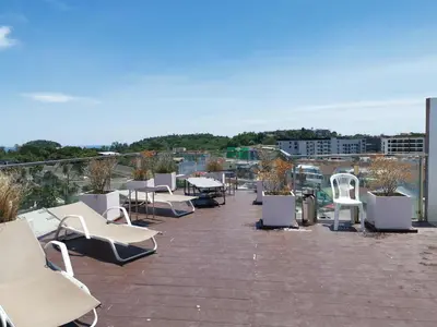 a group of chairs and tables on a roof at 7 Floor - Ozone Condotel near Kata beach by 15 minutes walking in Kata Beach
