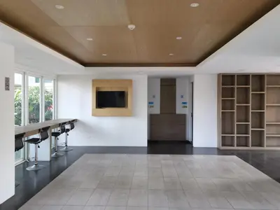 a room with a table and a tv on a wall at 7 Floor - Ozone Condotel near Kata beach by 15 minutes walking in Kata Beach