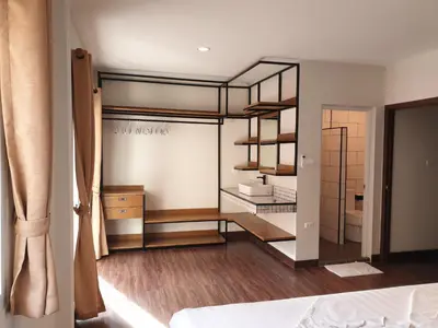 a room with a bed and a room with shelves at My Friend's House Villa in Karon Beach