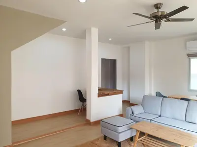 a living room with a blue couch and a table at My Friend's House Villa in Karon Beach
