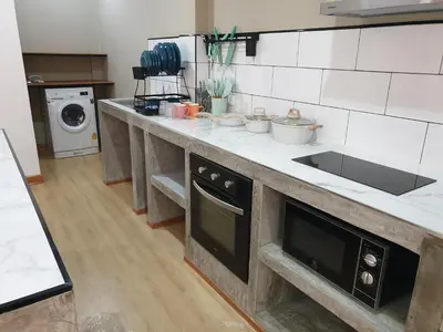 a kitchen with a counter with a sink and a dishwasher at My Friend's House Villa in Karon Beach