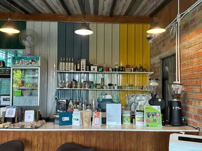 a counter in a restaurant with a counter top with drinks at Liang's Home เหลียงโฮม in Ban Riang