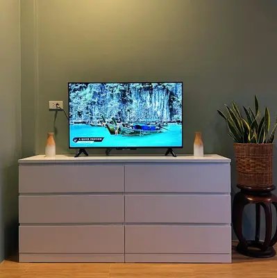 a television sitting on top of a dresser at Liang's Home เหลียงโฮม in Ban Riang