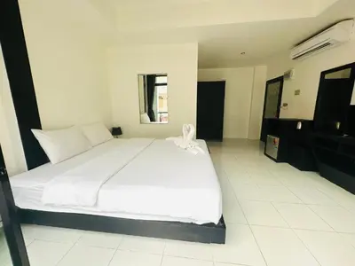 a bedroom with a large white bed in a room at Beachwalk Patong in Patong Beach