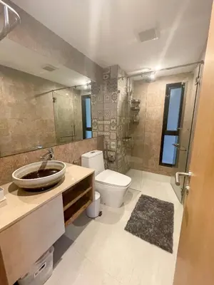a bathroom with a sink and a toilet and a mirror at The Title V Condos by Gregory in Rawai Beach