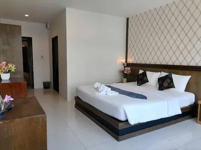a bedroom with a large bed in a room at NJ PATONG HOTEL in Patong Beach