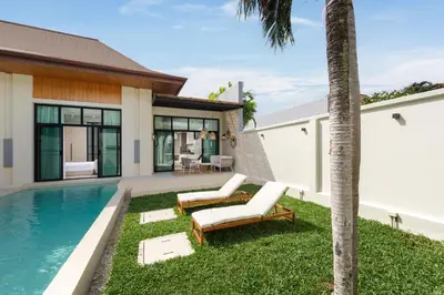 a villa with a swimming pool and a house at Onyx Villas by TropicLook in Nai Harn Beach