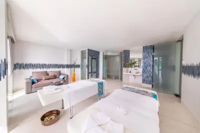 a living room with two beds and a couch at Villa La Prana in Phuket Town