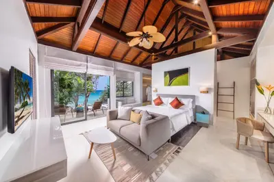 a bedroom with a bed and a couch at Villa La Prana in Phuket Town