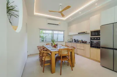 a kitchen with a table and chairs in a room at Modern Rustic 4 Bedrooms Villa, Walk to Rawai & Yanui Beach in Nai Harn Beach