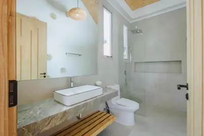 a bathroom with a sink and a toilet at Modern Rustic 4 Bedrooms Villa, Walk to Rawai & Yanui Beach in Nai Harn Beach