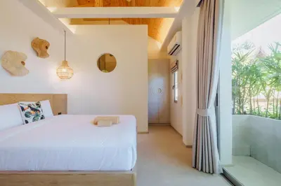a bedroom with a bed and a large window at Modern Rustic 4 Bedrooms Villa, Walk to Rawai & Yanui Beach in Nai Harn Beach