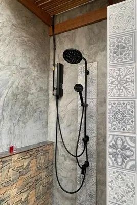 a shower in a bathroom with a shower at Forest Bungalows & Mama's Restaurant in Chalong