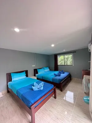 two beds in a room with blue sheets at View Garden Resort in Phi Phi Don