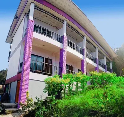 a building with purple columns and balconies on it at View Garden Resort in Phi Phi Don