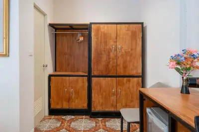a wooden cabinet in a room with a desk at Oceanview Bungalows by EAT in Karon Beach