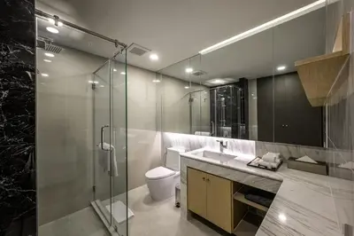 a bathroom with a shower and a toilet and a sink at Уютные апартаменты в Mide Grant in Phuket Town