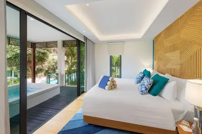 a bedroom with a bed and a swimming pool at Club Wyndham Sea Pearl Phuket in Patong Beach