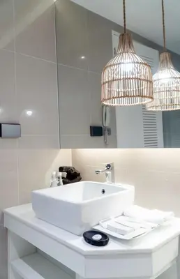 a white bathroom with a sink and two lights at Club Wyndham Sea Pearl Phuket in Patong Beach