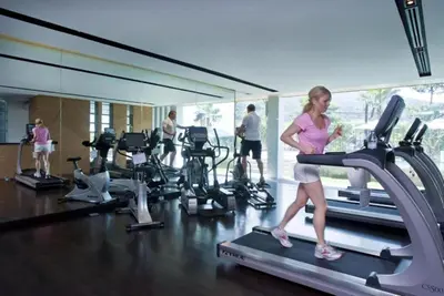 a woman running on a treadmill in a gym at Club Wyndham Sea Pearl Phuket in Patong Beach