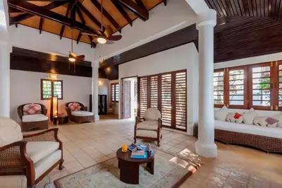 a living room with a couch and a table at Baan Khunying - Secluded Phuket Beachfront Villa in Rawai Beach