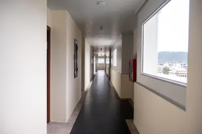 a long hallway with a window in a building at GP House Phuket Patong Beach in Patong Beach
