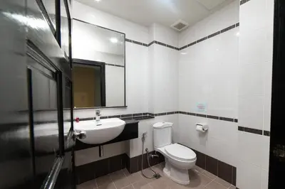 a bathroom with a toilet and a sink and a mirror at GP House Phuket Patong Beach in Patong Beach