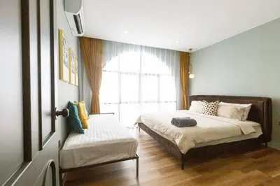 a bedroom with two beds and a window at Cozy Patong Beach House 3 Bedrooms in Patong Beach